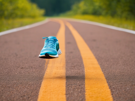 Shoe is floating up in the air on a road.