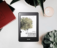 Kindle with book Dividing Sword with a succulent plant and a candle