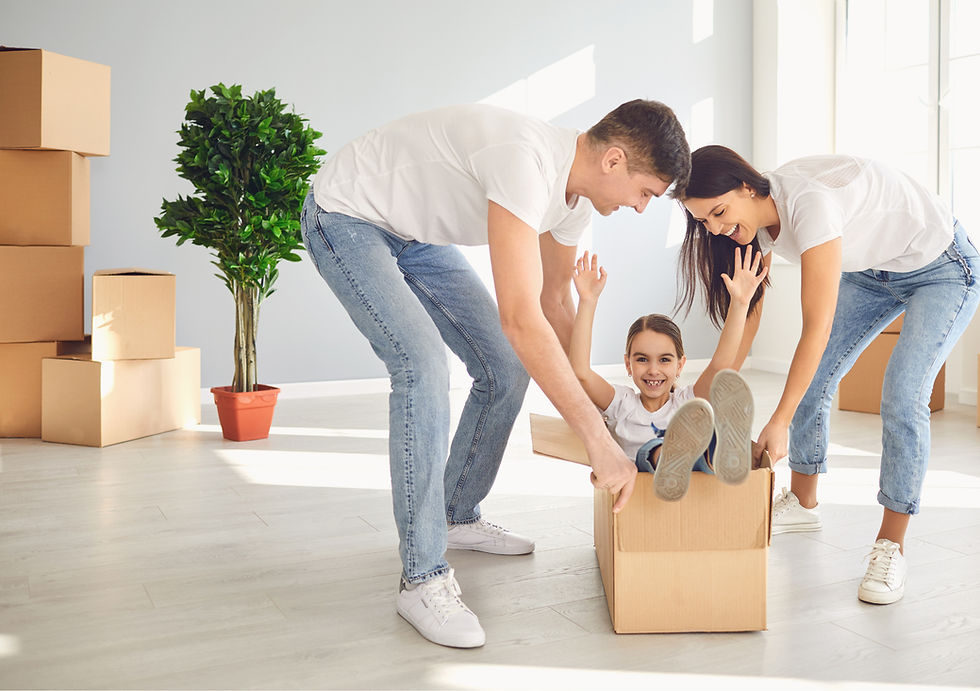 Family having fun while moving into new home, child sitting in a box
