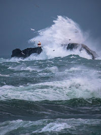 Powerful Atlantic storm creating dramatic waves and moody photography conditions in the Faroe Islands.