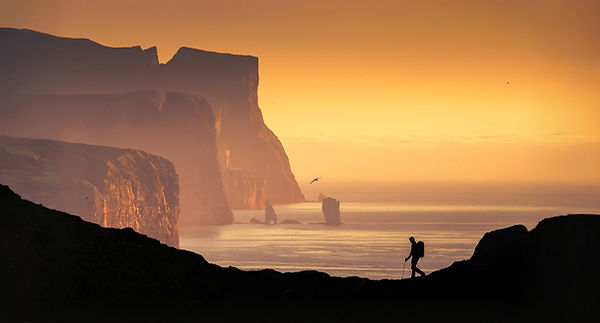 Photographer crossing a ridge during a Faroe Islands Photo Tour with Andrija Ilic Images