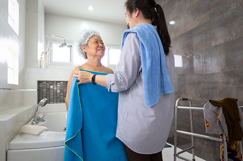 in-home caregiver performing laundry tasks as part of light housekeeping in NJ