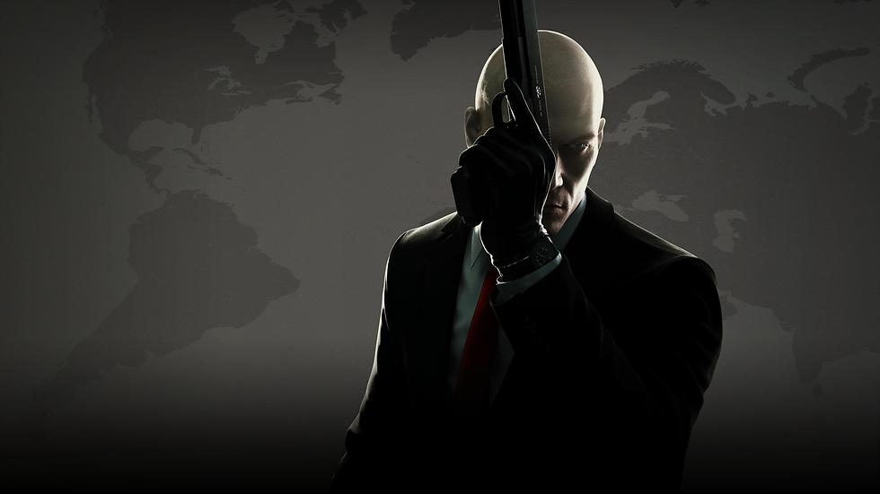 Bald man in black suit and gloves holds a pistol vertically over his face against a dark world map backdrop.