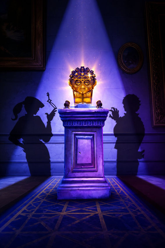 Cinematic vertical poster of a dimly lit museum heist scene inspired by Thick As Thieves, featuring a glowing golden artifact on a stone pedestal under a dramatic spotlight, while two shadowy thief silhouettes lurk on opposite sides of the room in purple-blue lighting, creating a tense stealth atmosphere.