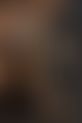 Masked PAYDAY 3 heisters outside a luxury bank at night, one in a brown trench coat giving a thumbs-up while holding an assault rifle, as two crew members point at each other in a chaotic peer-to-peer standoff.