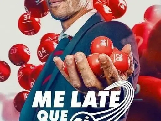 A confident man in a suit stands surrounded by floating red lottery balls, holding several in his hand with a sly grin — the perfect image of a charming scam artist who just figured out how to cheat luck itself.