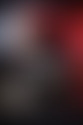 Gritty crime game poster showing a rugged man with a bruised face, a muscle car racing through a red-lit industrial city, and armed figures in the background, capturing a tense underworld atmosphere of violence and survival.