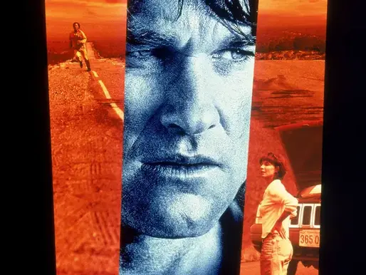 Stylized movie poster for Breakdown (1997) showing a tense close-up of Kurt Russell’s face split by red desert panels, with a stranded couple on a highway and a broken-down car under a burning sky.