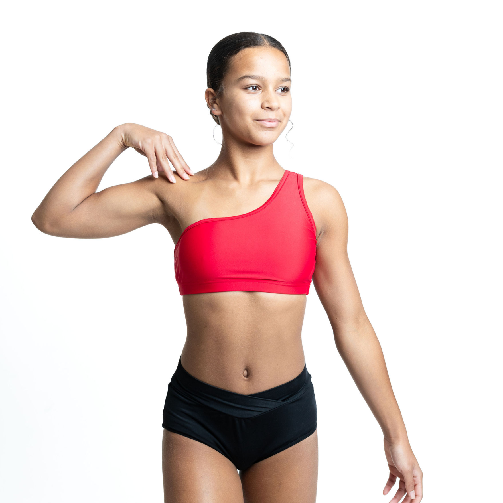 Dancer in red one-shoulder crop top and black shorts.
