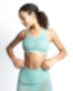 Thumbnail: Close-up of dancer in mint asymmetrical-strap crop top and matching sheer skirt, adjusting the waistband.