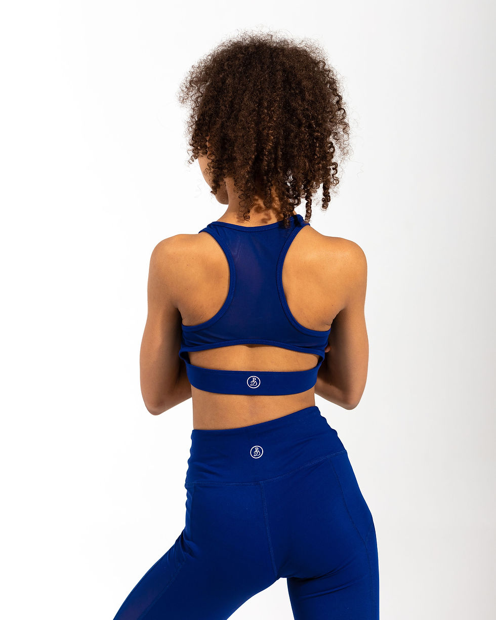 Back view of royal-blue sports bra with cutout band and matching leggings.