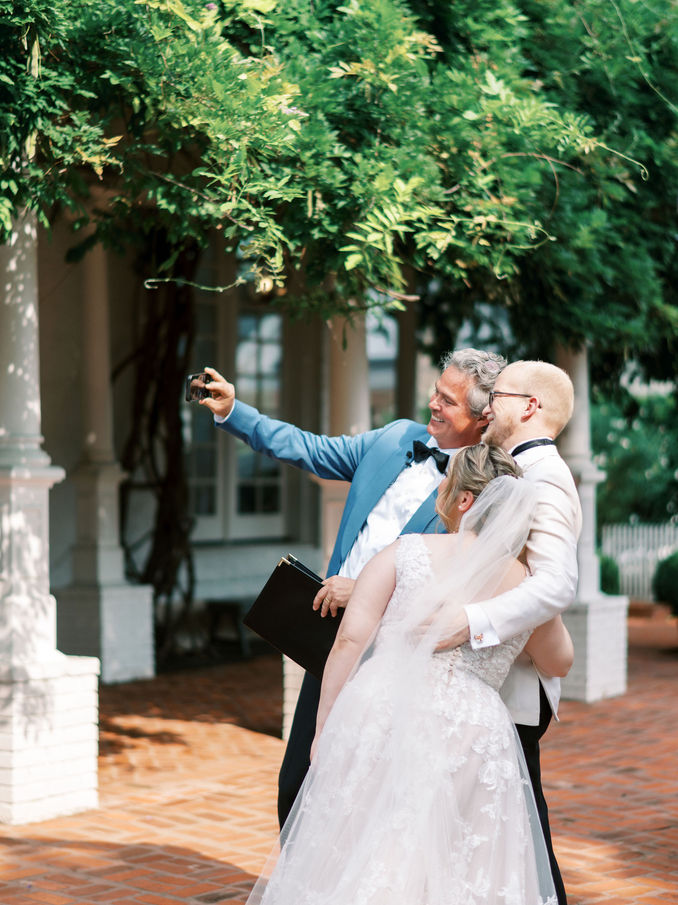 Groomsmen celebrating outside during summer wedding.