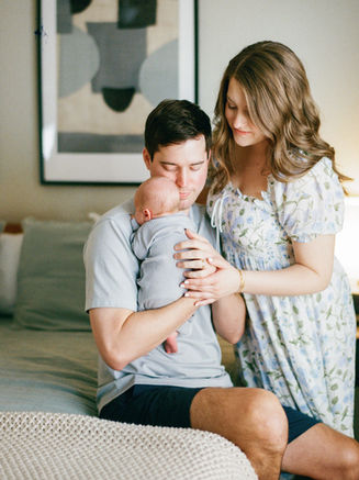 Austin newborn photographer capturing parents holding their 3 week old baby during in-home lifestyle newborn session