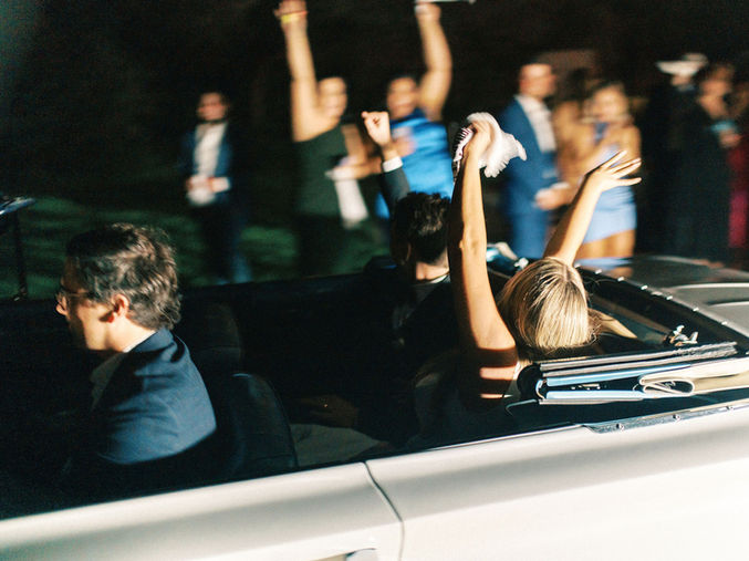 Couple celebrating in getaway car photographed by a Posey Meadows wedding photographer