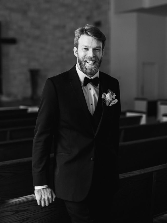Groom portrait in black tuxedo photographed by Briscoe Manor wedding photographer