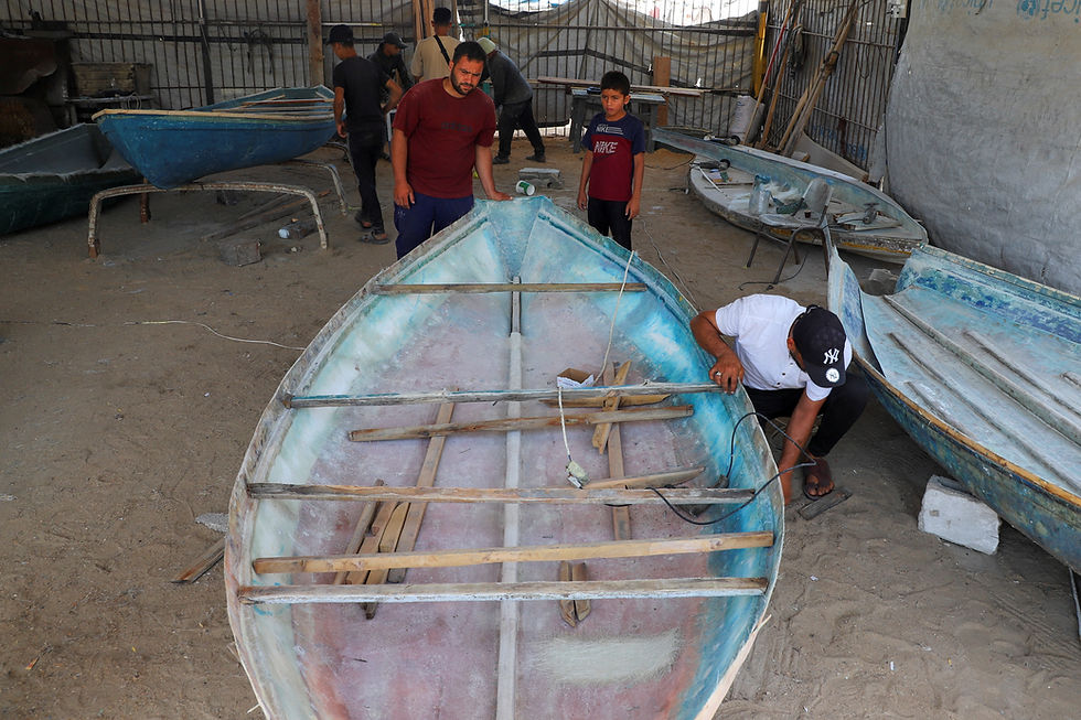 In Gaza, fishermen make small boats from wood, fiberglass pulled from rubble
