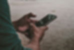 A photo of a man using a mobile phone courtesy of Unsplash via Wix.
