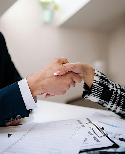 A handshake between a professional man and woman solidifying a business deal