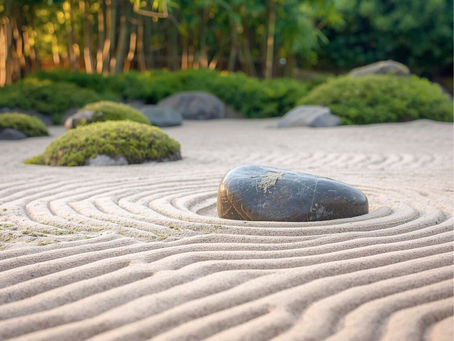 A serene Japanese Zen garden with raked sand patterns around smooth stones, lush greenery, and bamboo in the background under soft light. Representing blanced resilience.