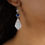 Thumbnail: Blue Quartz, Freshwater Pearl and Carved Shell Earring-on model