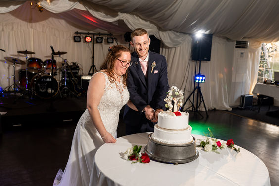 Plum park cutting wedding cake
