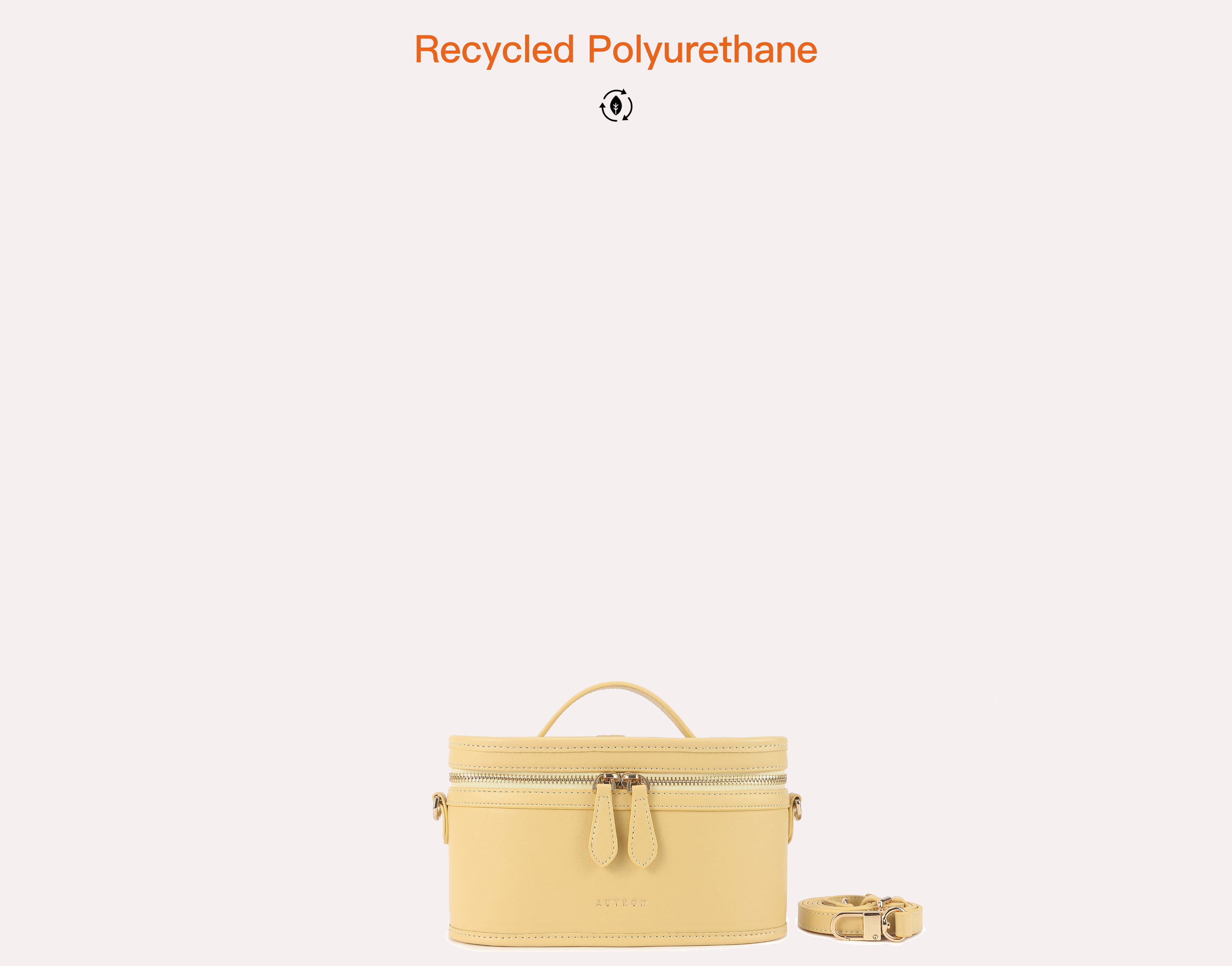 Pale yellow structured vanity bag with top handle, double zipper pullers, detachable strap, and gold-tone hardware.