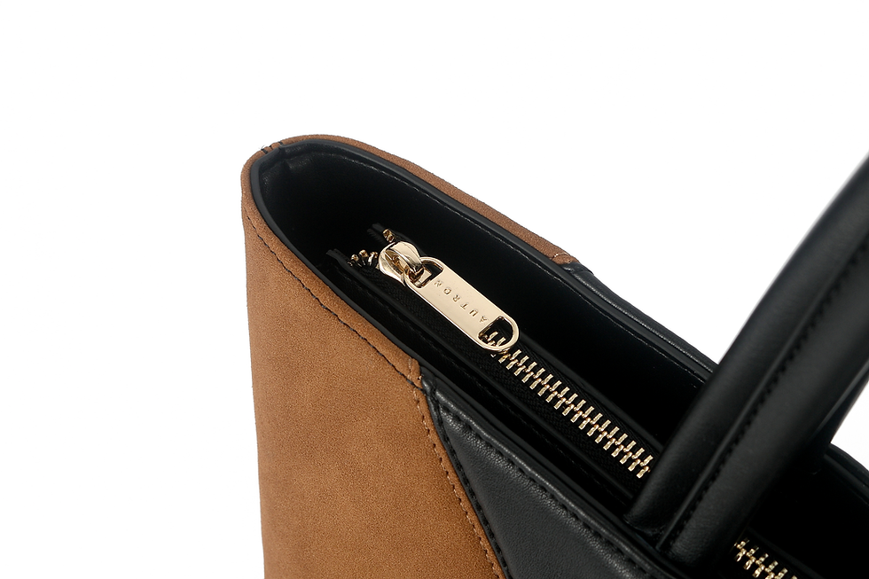 Thumbnail: Large black and caramel two-tone tote bag with chevron panels, long shoulder handles, and a small AUTRON logo plaque.
