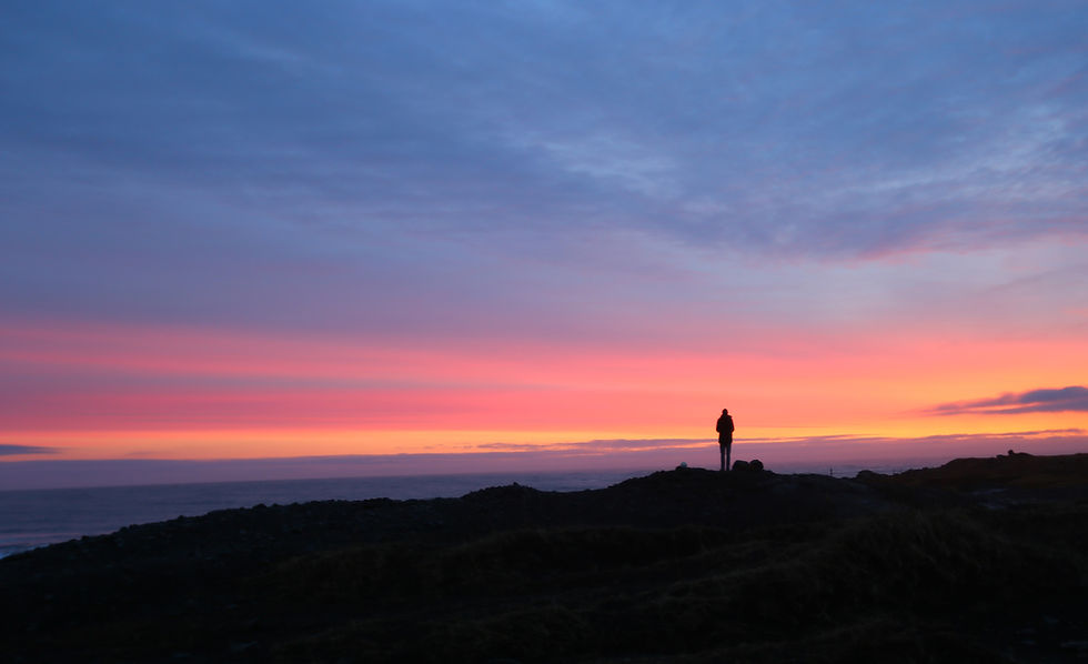Sunrise at Stokksnes, Iceland, endless sky punctuated by a lone human