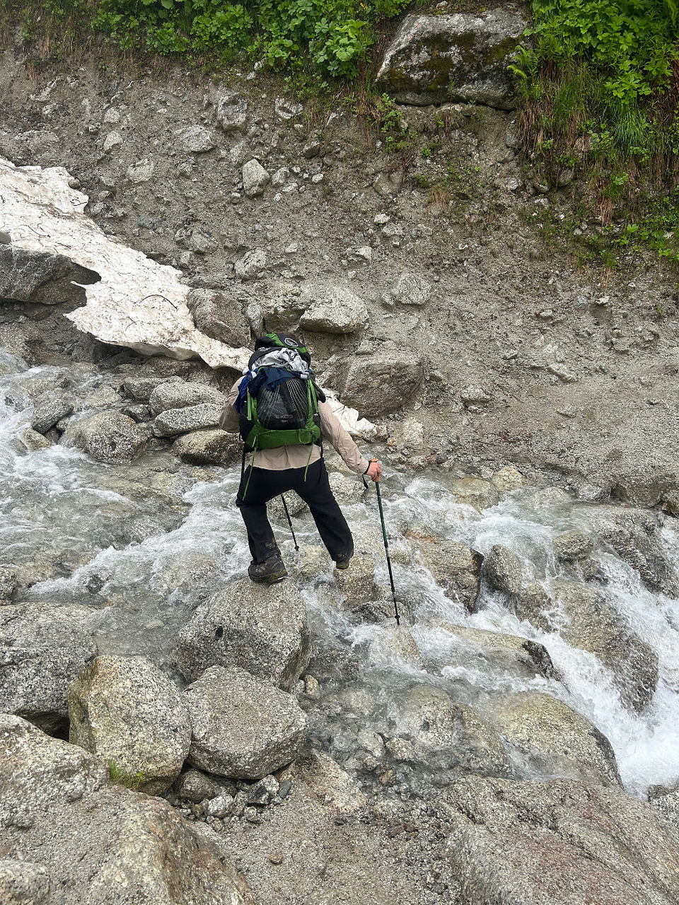 Using trekking poles to jump over a stream