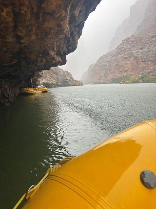 Rafting the Grand Canyon: Ducking under a Supai rock shelf on the Colorado River