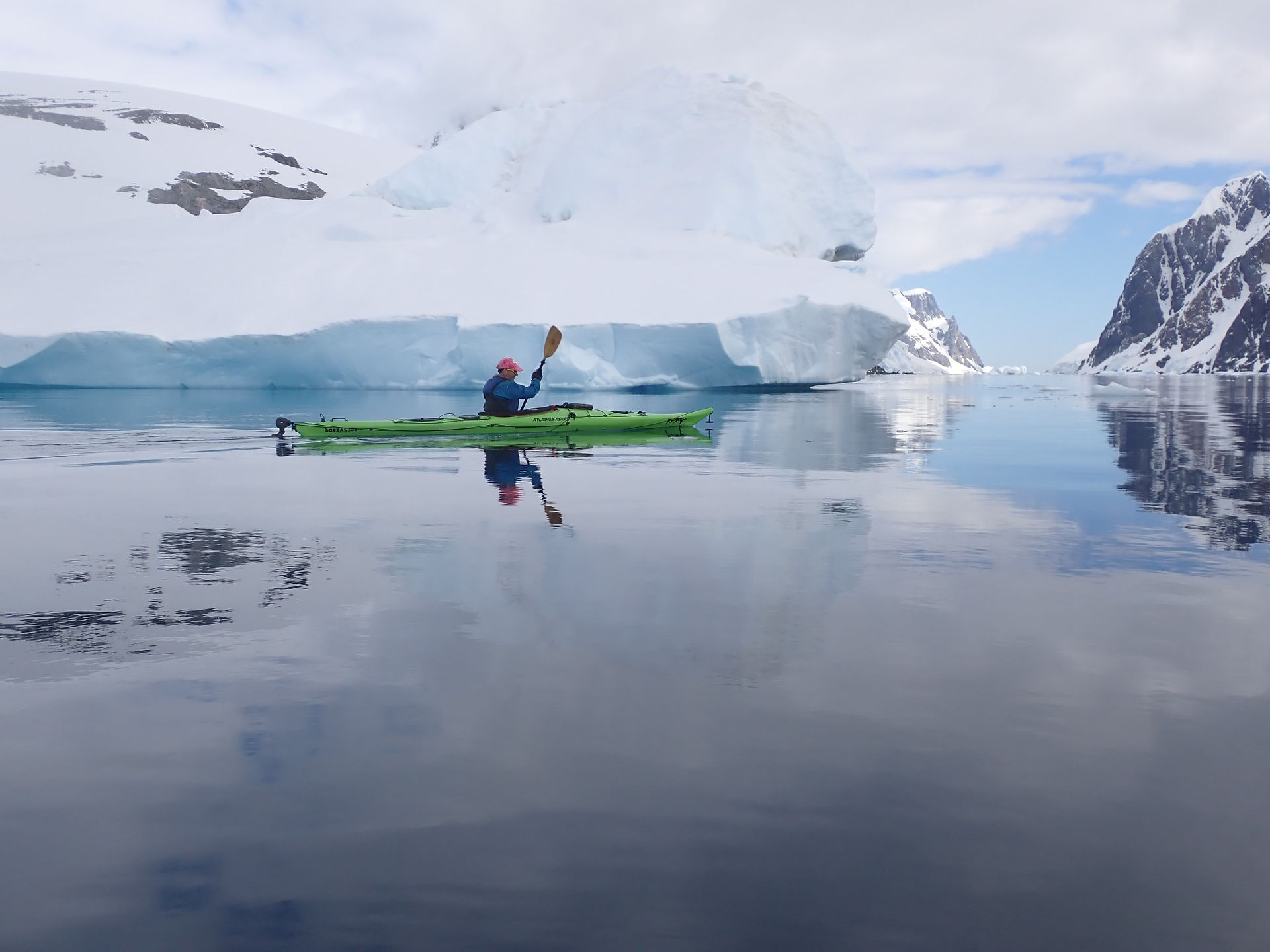 Oren paddling in the reflective water of the Lemaire Channel