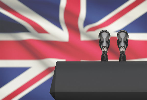 Speakers podium in front of a Union Jack Flag