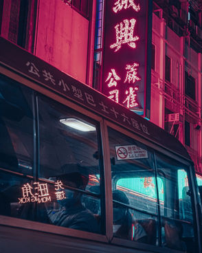 A bus filled with commuters is waiting for departure at its terminal station at nighttime Hong Kong.