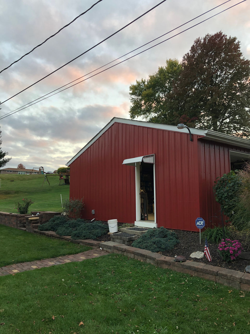 A classic red siding exterior has been revitalized through a remodeling process. The updated look combines traditional charm with modern elements for a fresh and inviting appearance.