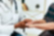 doctor holding patients hand