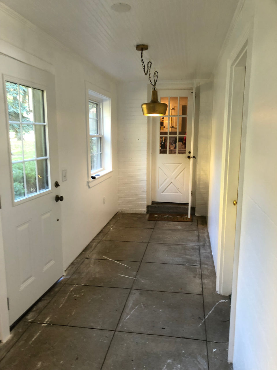 This family is enhancing their home's comfort and energy efficiency by replacing old windows with new ones. Additionally, they are expanding their living space by enclosing their porch, creating a new indoor area for year-round.