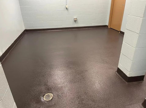 Dark brown epoxy flooring installed in basement