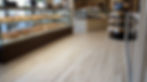 Bakery interior with pastries and light wood flooring
