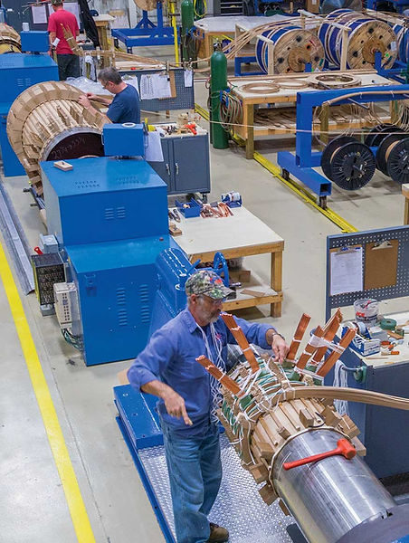 Interior of OTC's manufacturing area featuring industrial bake-out ovens and vacuum chambers