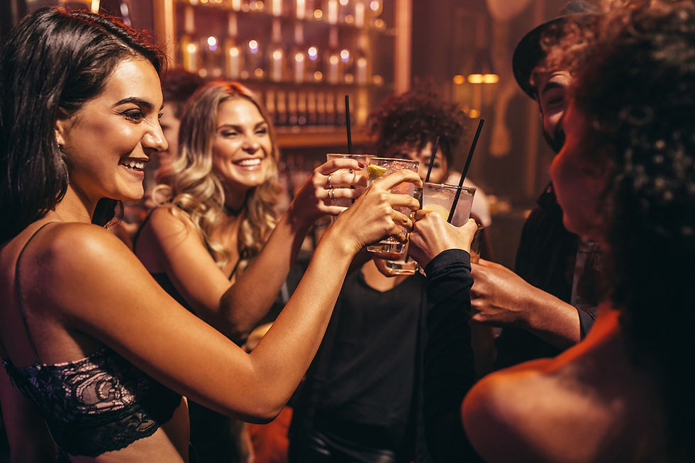 A group of people toasting with cocktails at an office party