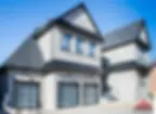 Modern house with light stone exterior and two garage doors