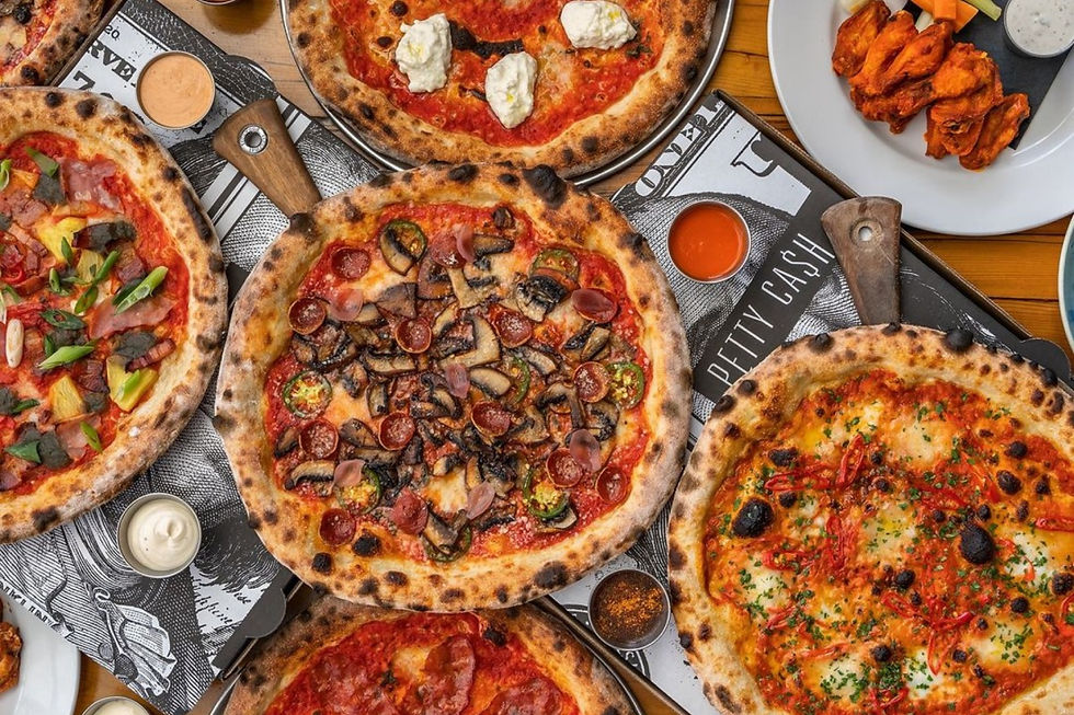 Overhead shot of a table full of pizzas from Petty Cash