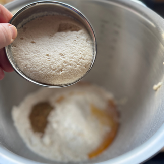 adding activated dry east to the bread flour mix