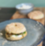 homemade Bagel with cream cheese and garlic -coriander oil served on a plate ready to eat