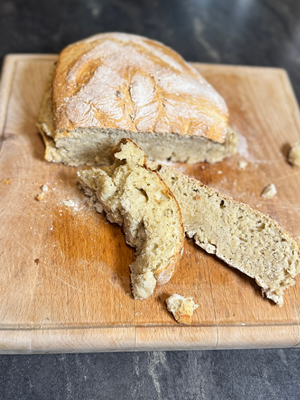 Alt Text: Ingredients for homemade spelt and wheat bread with honey and bread spice on a wooden counter