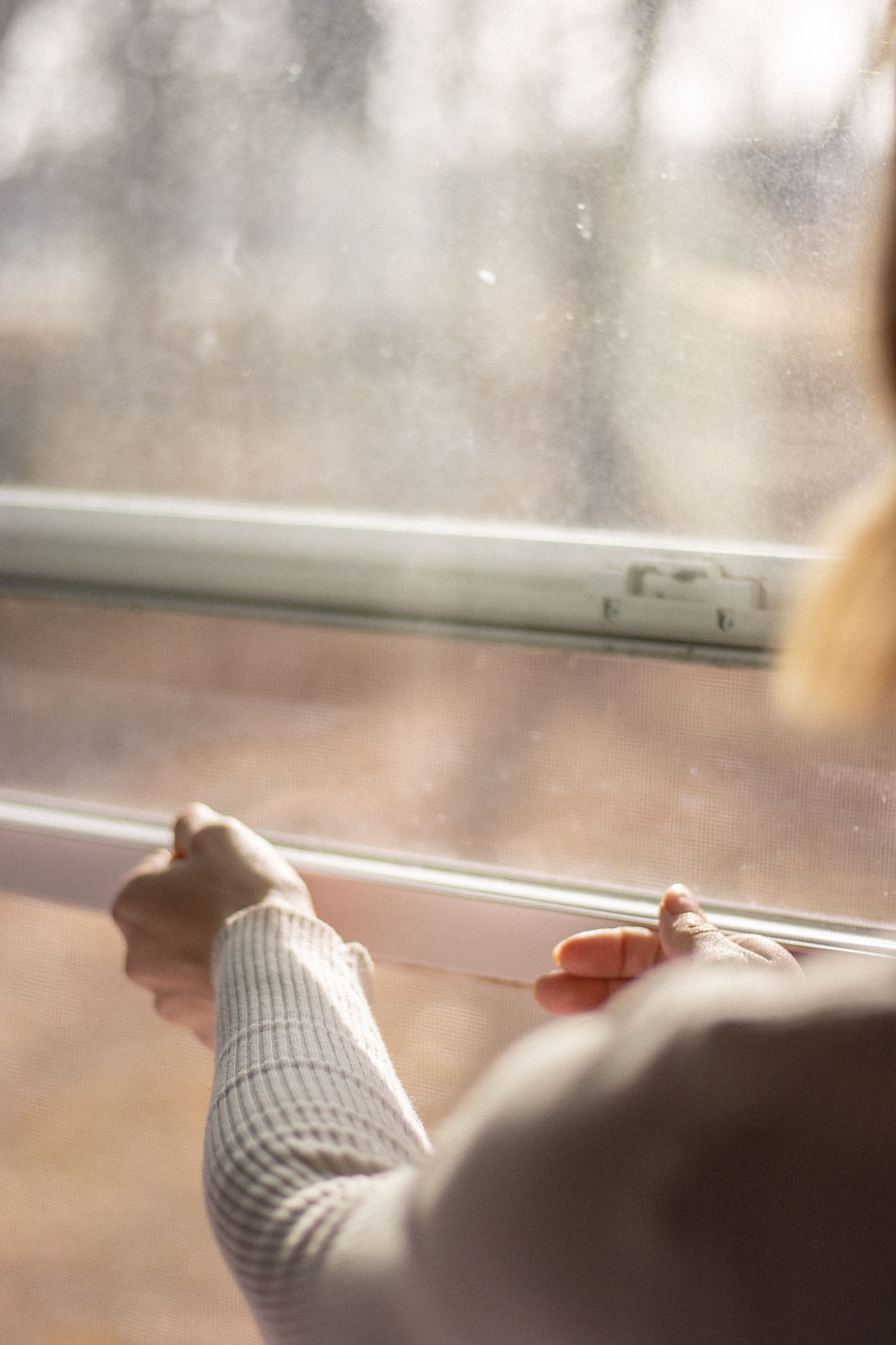 person closing window