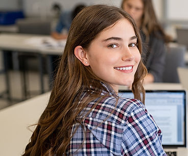 Student smiling in a classroom