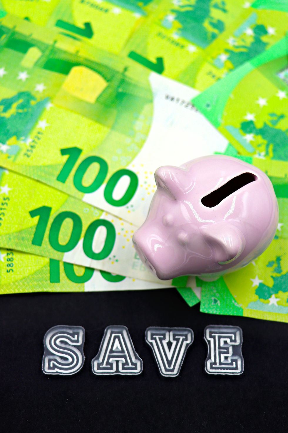 piggy bank with money beside it with "save" underneath