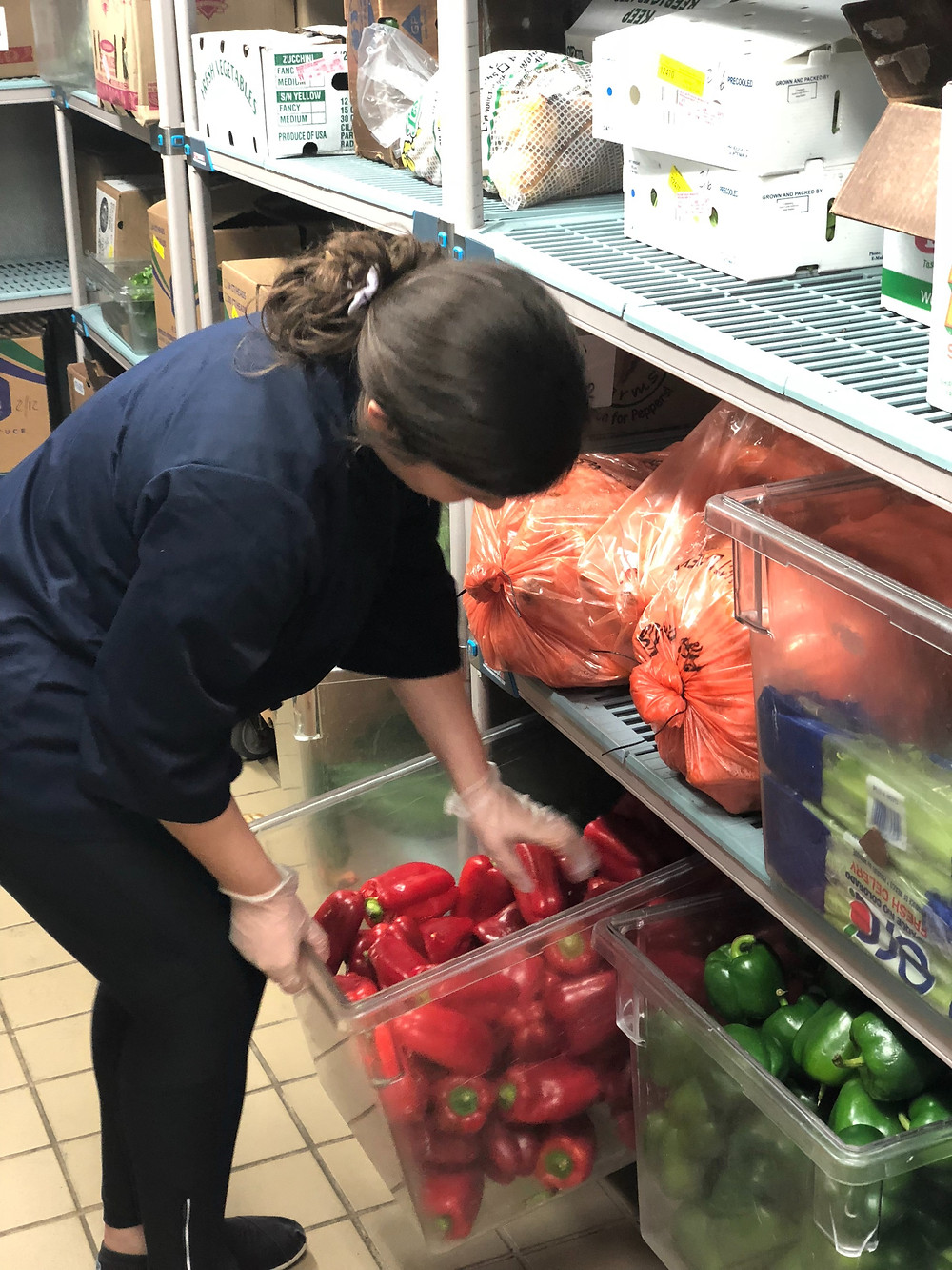 A UNF cafe worker handling peppers in the cafe.