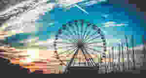 Silhouette of a ferris wheel at sunset.